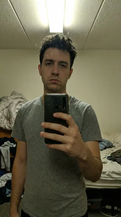 Casual selfie of young professional man before AI photo enhancement