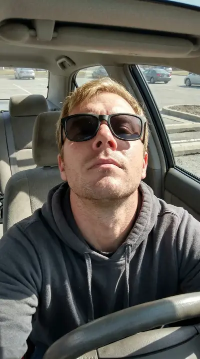 Outdoor selfie of man with beard before AI dating photo upgrade